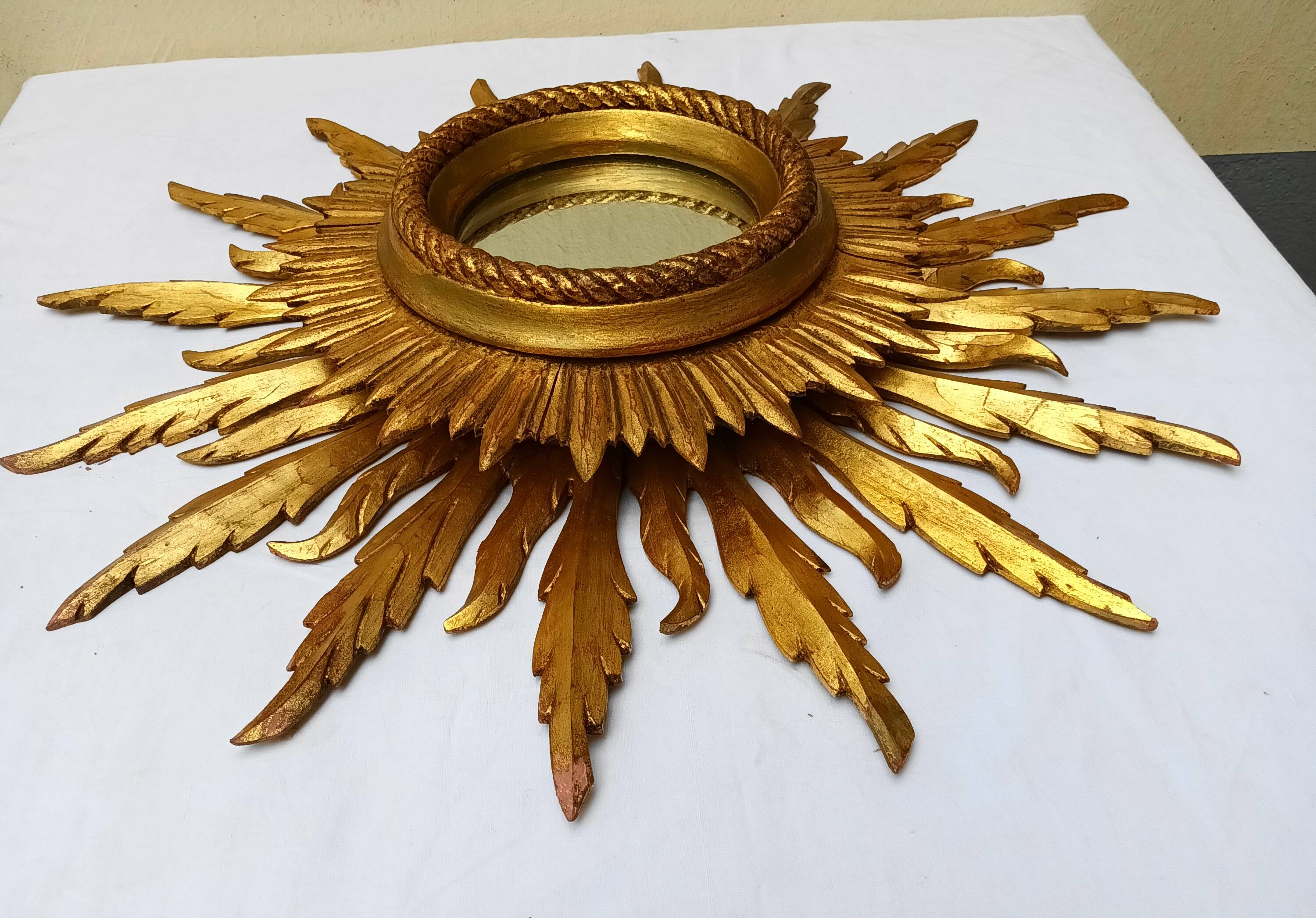 Sun mirror in carved gilded wood from the 1950s