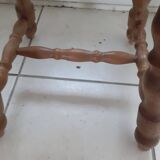 Rectangular wooden stool with 4 turned legs.