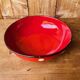 Ceramic salad bowl in red with white polka dots.