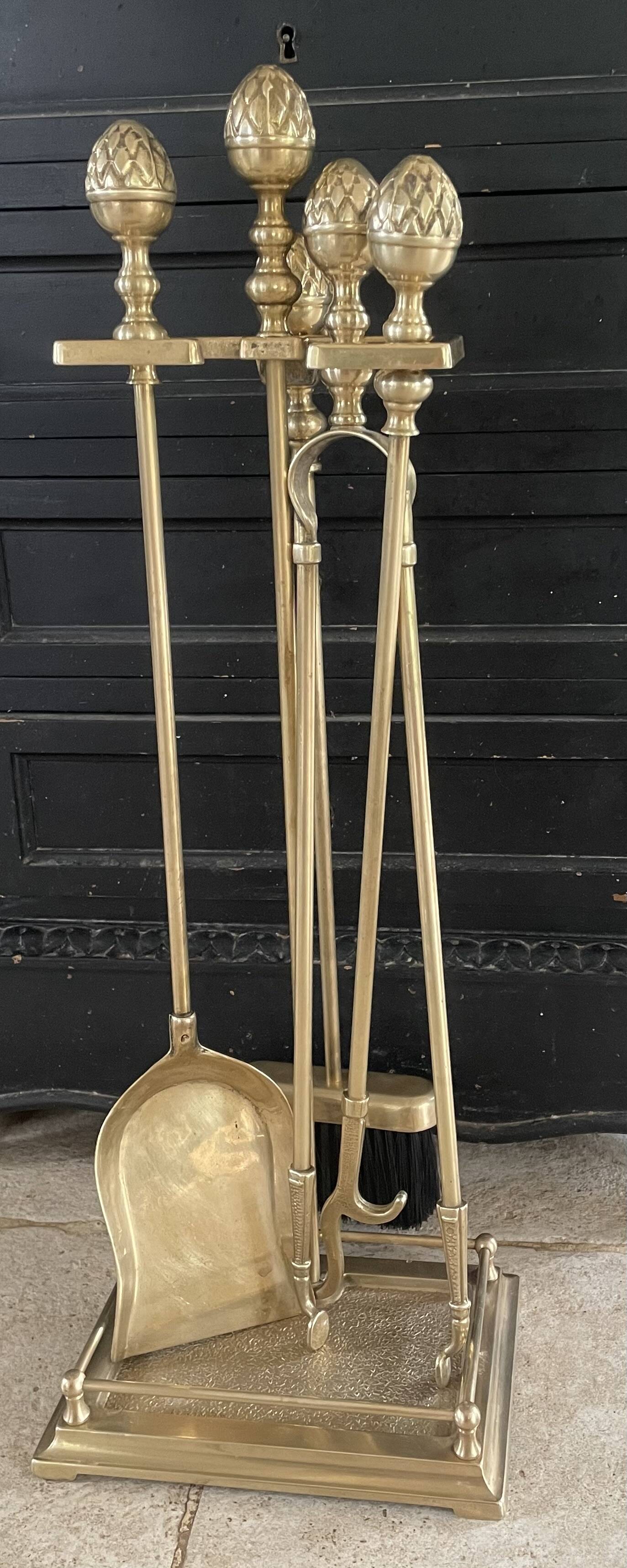 Brass fireplace tools in the style of Maison Baguès.