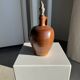 Ancient stoneware jug with a pewter spout.