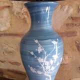 Large blue porcelain lamp with white flowers (cherry blossoms) on wooden stand.