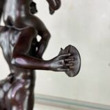 Dionysus on the shoulders of a satyr, bronze after the antique on a yellow Siena base.