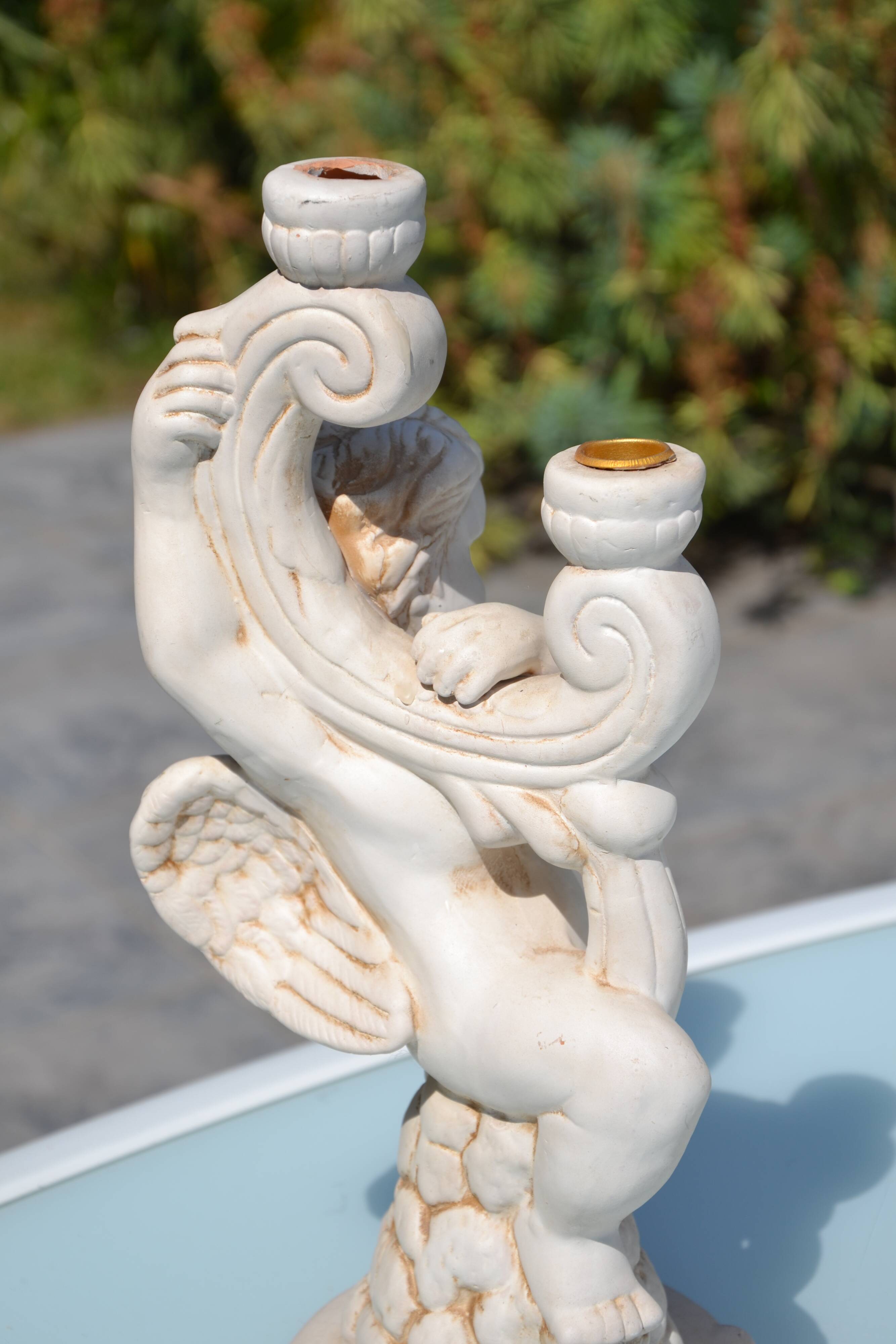 Pair of "cherub" candle holders in plaster
