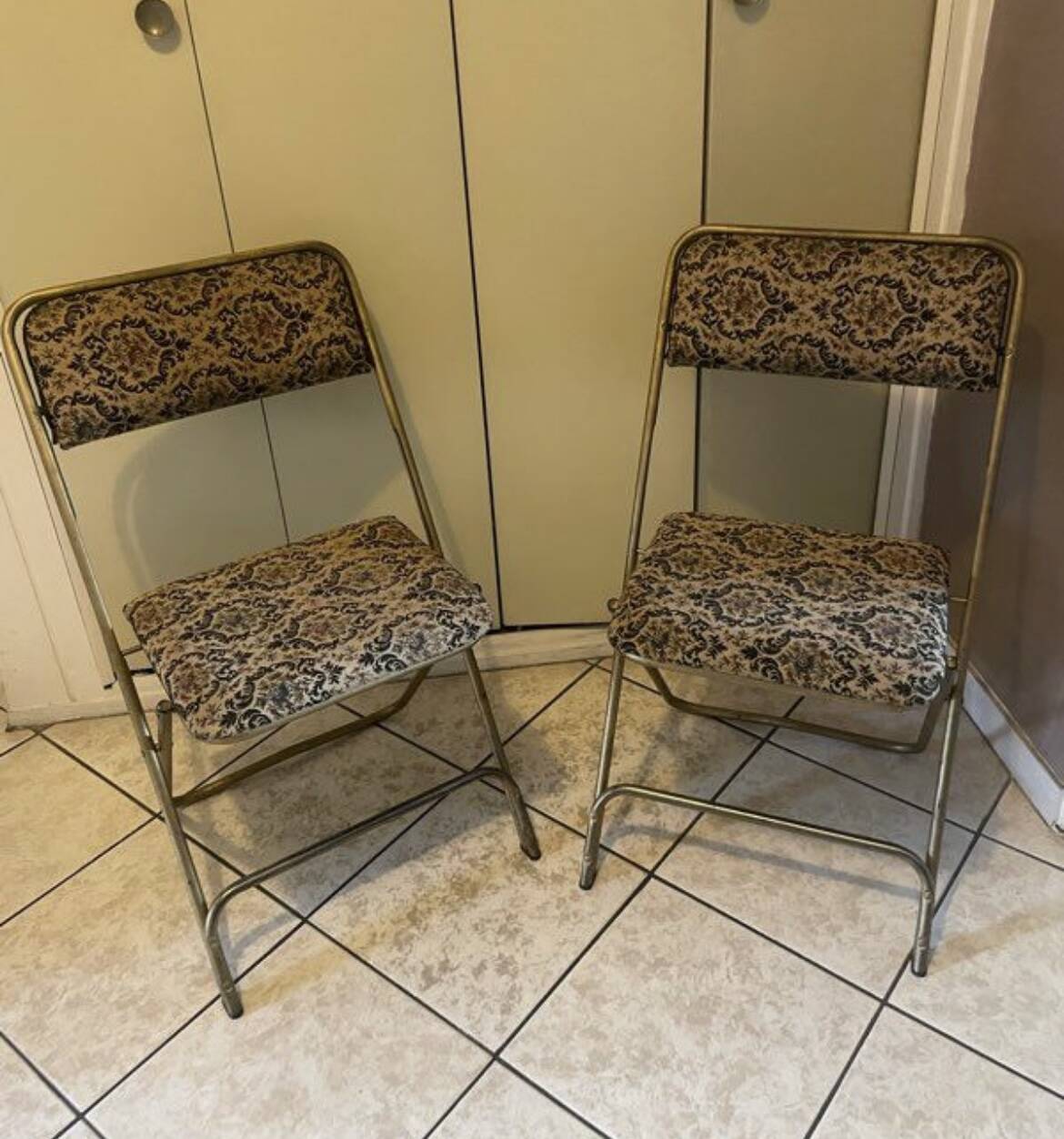 Two antique Manufrance folding chairs in metal and fabric