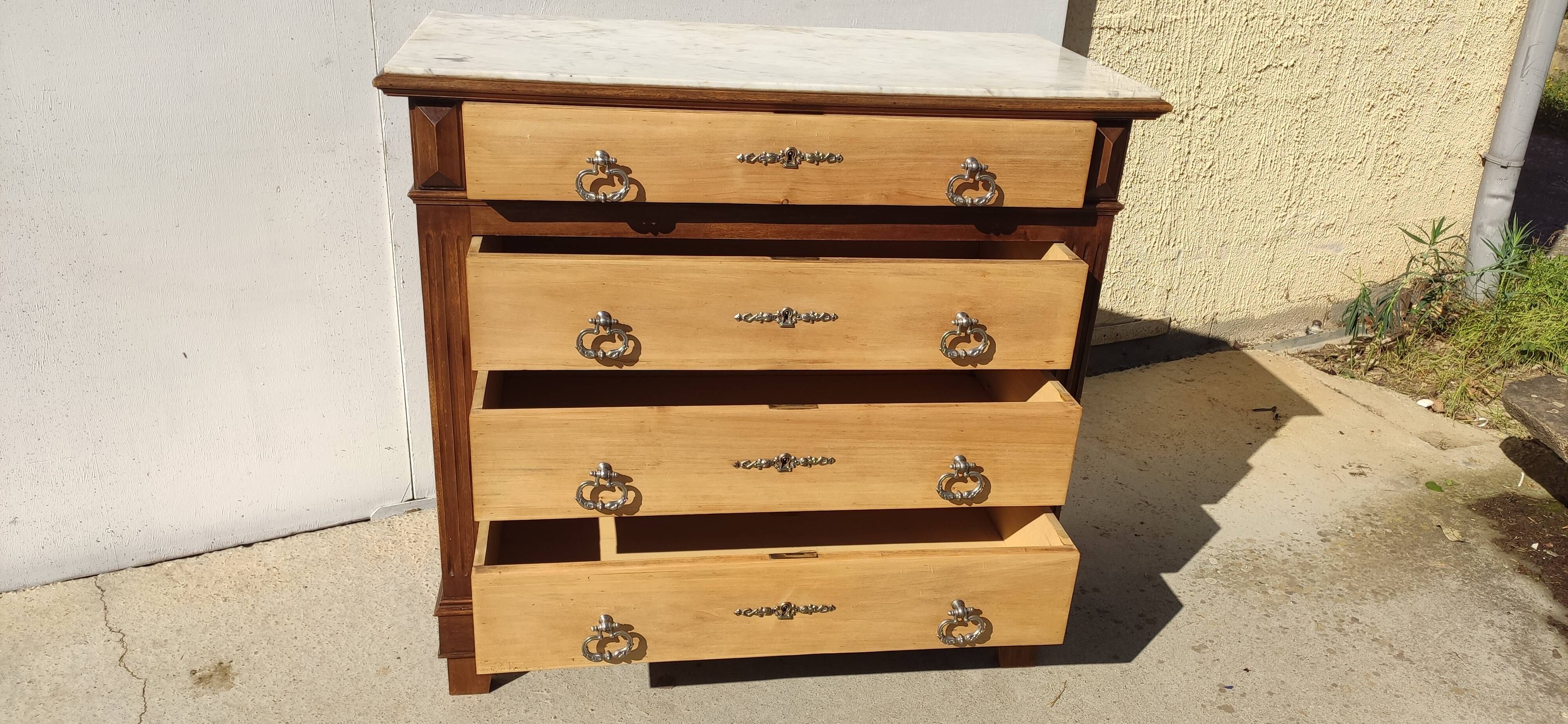 Old chest of drawers with white marble.