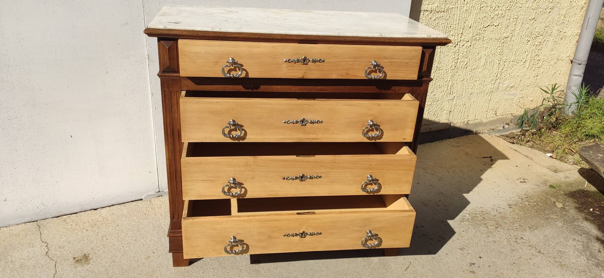 Old chest of drawers with white marble.