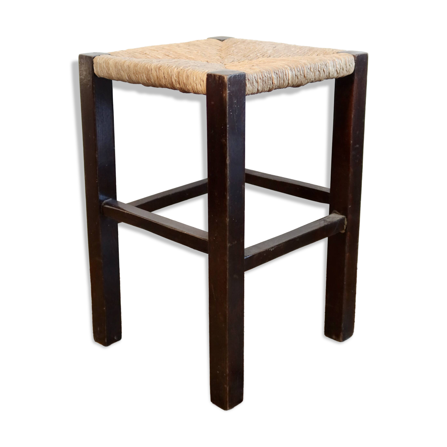 Vintage rustic stool in wood with a straw seat.