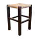 Vintage rustic stool in wood with a straw seat.