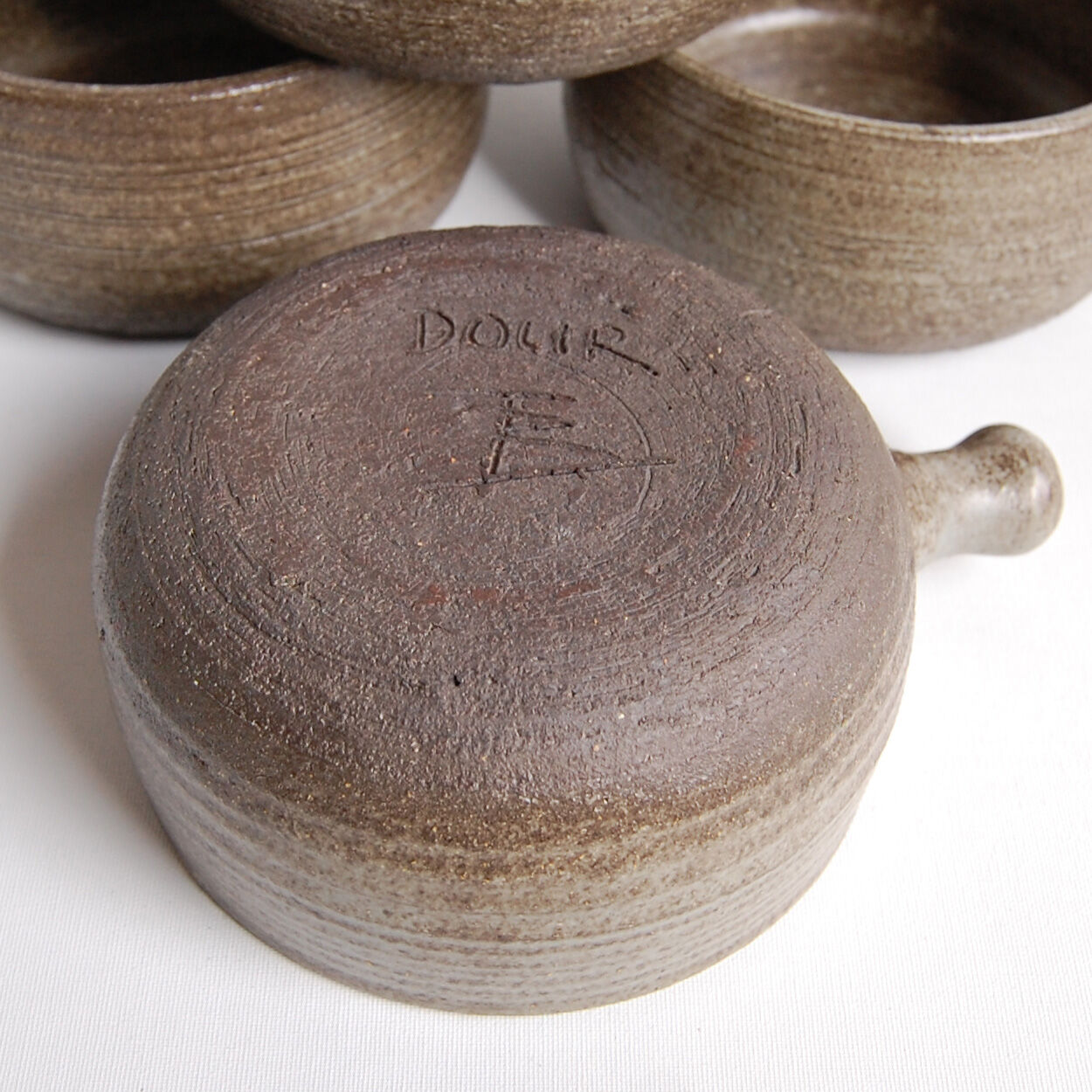 Set of 4 bowls and 4 plates by Thèrèse Bataille for the workshop of Dour 1970s