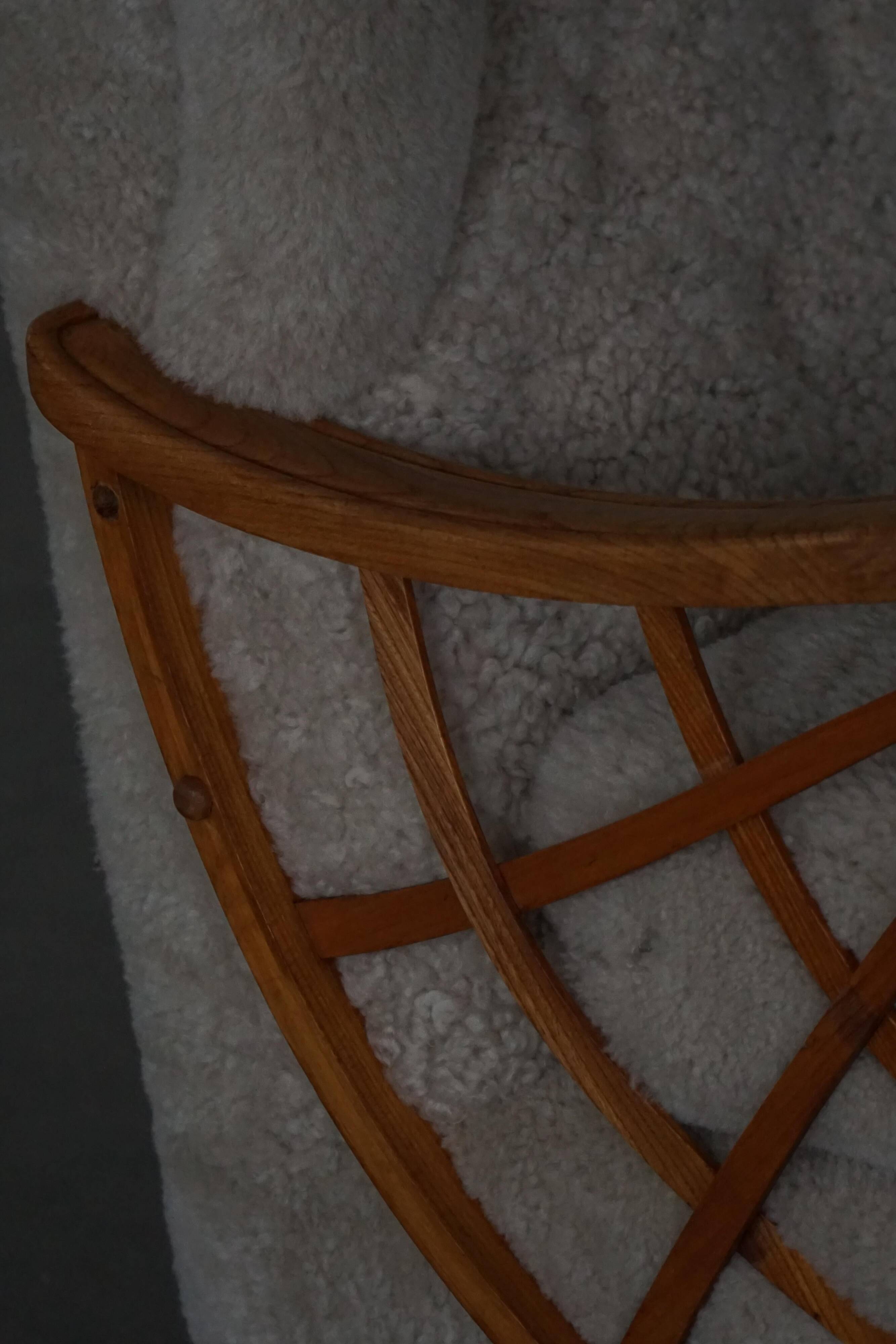 Pair of modern Swedish lounge chairs, shearling sheepskin and elm, 1940s.