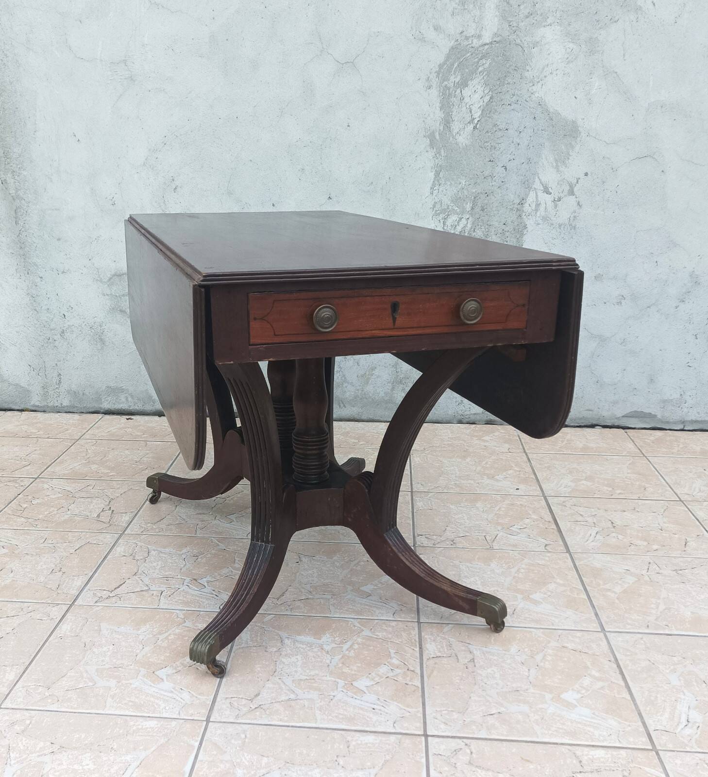 19th-century English style mahogany drop-leaf table.