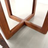 Modernist round table in solid elm, crossed legs.