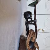 A large Senufo mask made of colored wood, decorated with an anthropomorphic figure