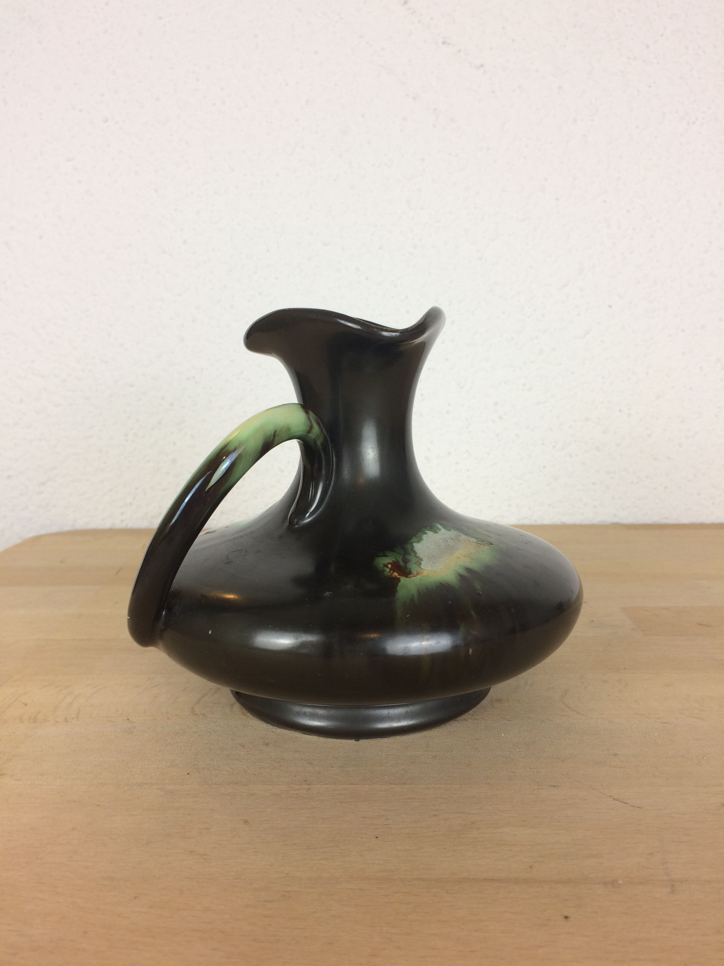 Thulin Belgium pitcher, black ceramic handle