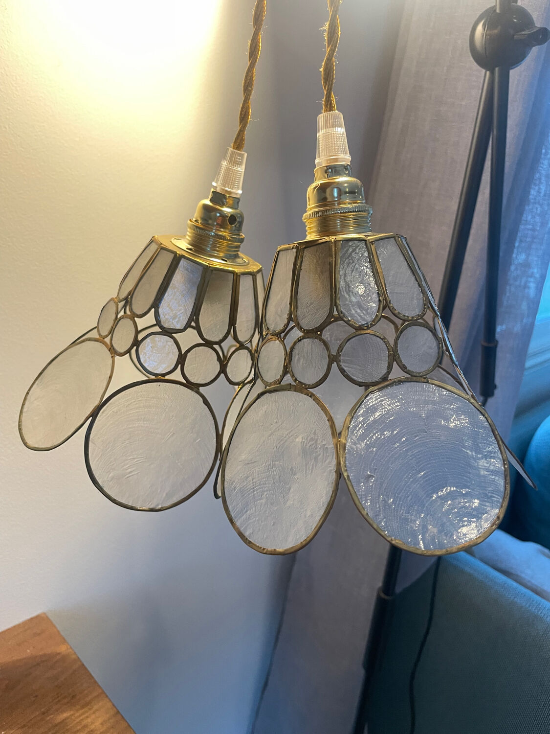 Pair of portable lamps with mother-of-pearl lampshades and brass.