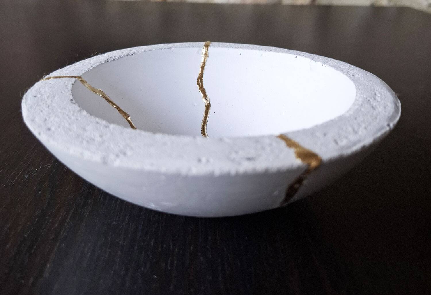 Concrete cup, tinted waxed, inlaid with gold leaf drips in a Kintsugi inspiration