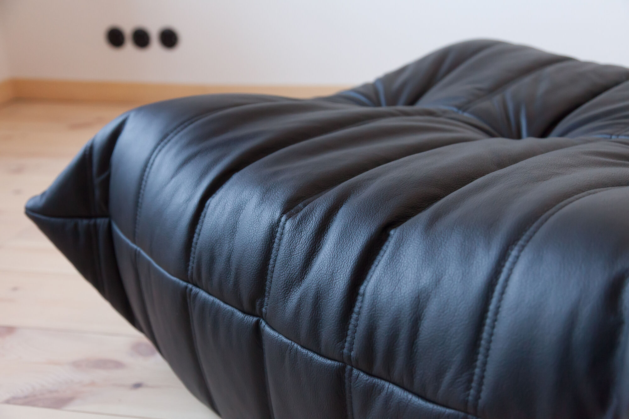 Armchair and ottoman in black leather model designed by Michel Ducaroy 1973
