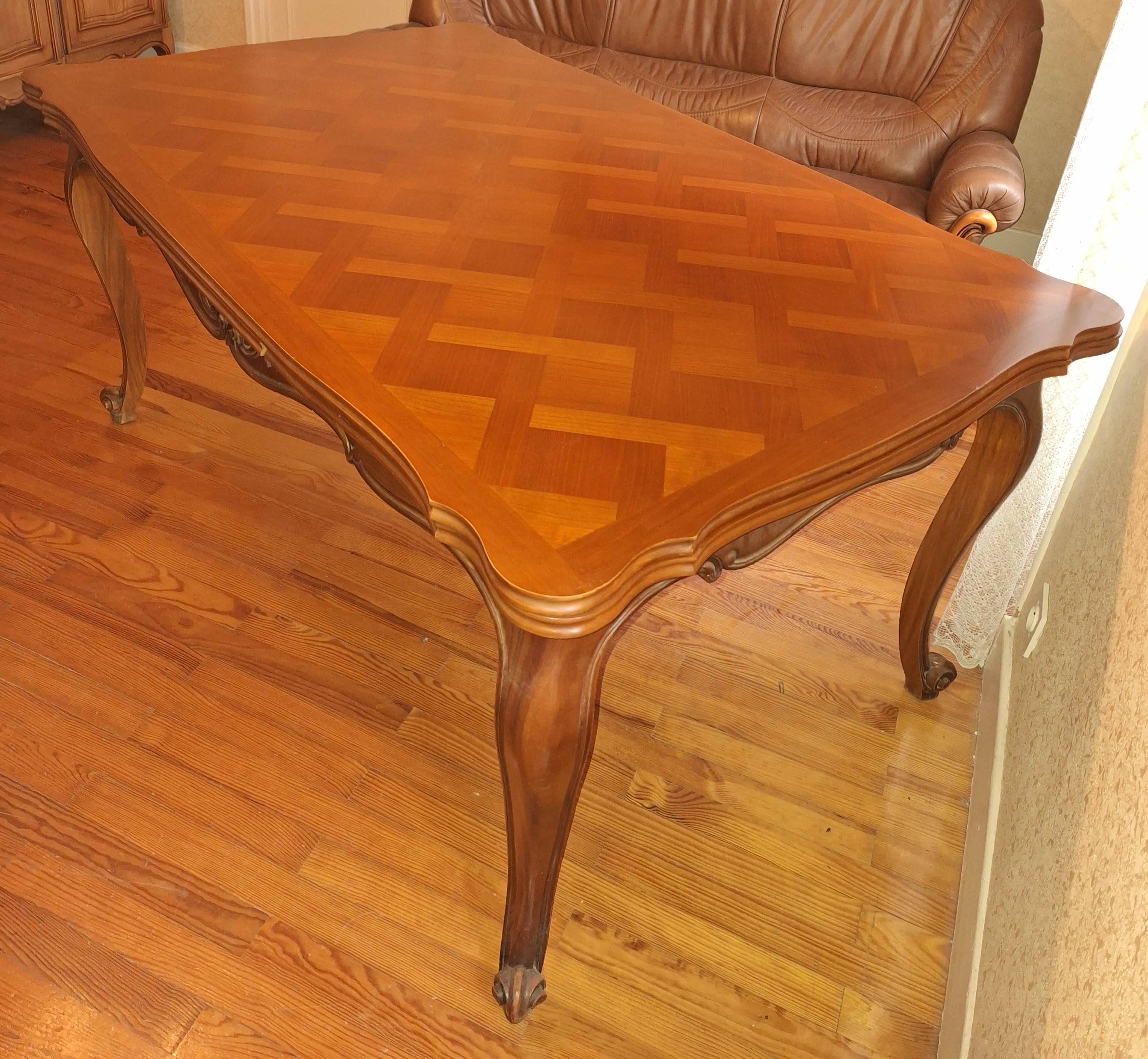Extendable table in Louis XV style made of solid cherry wood and marquetry.