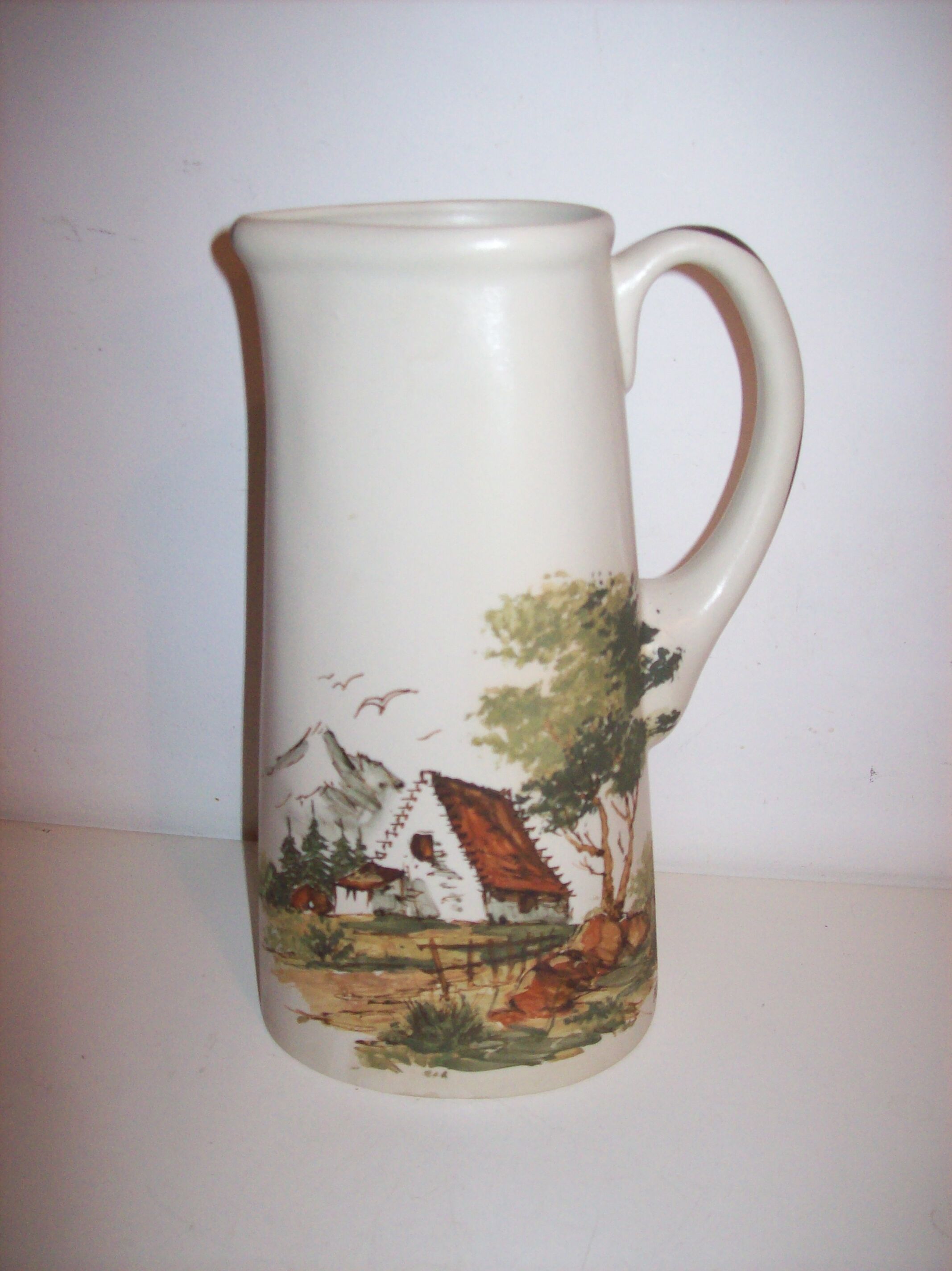 Ceramic pitcher with hand-painted decoration