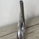 Sculptural vase design in polished aluminium.