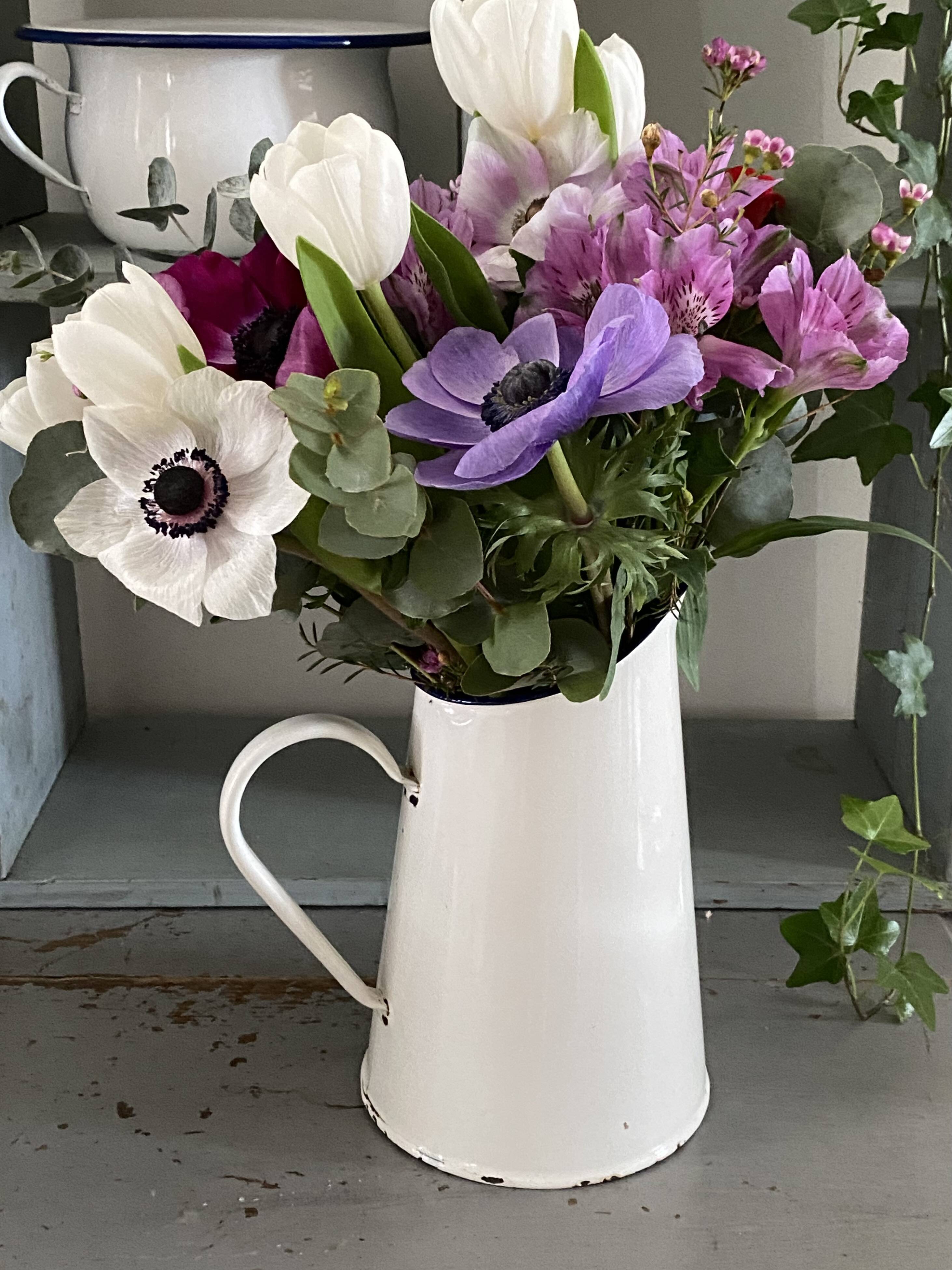 Old white enameled pitcher