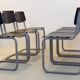 Ensemble de six chaises industrielles en contreplaqué Gispen dans un cadre gris et wengé.