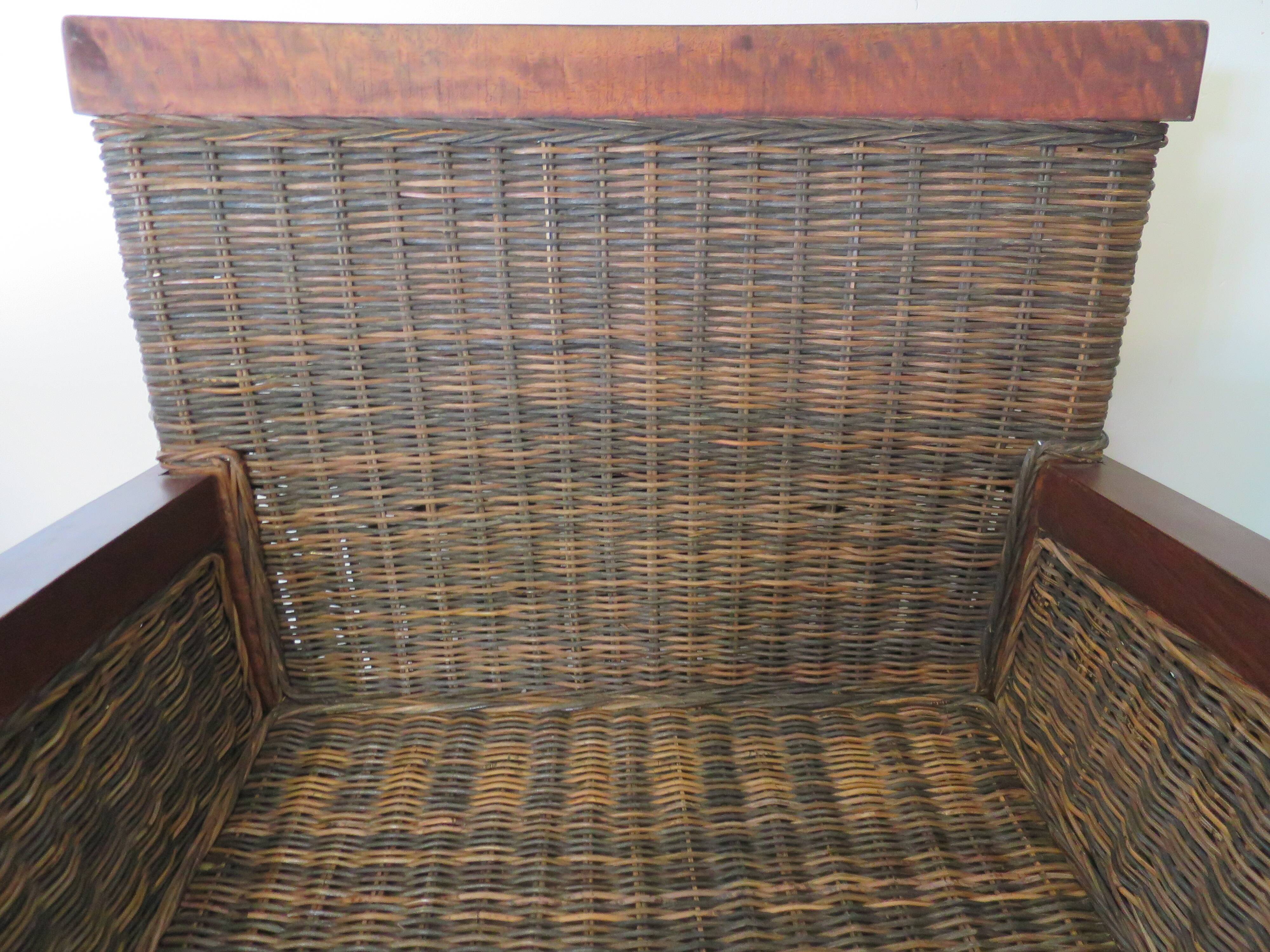 2 colonial-style armchairs in woven rattan and exotic wood