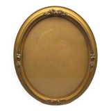 Old oval frame in wood and gilded stucco