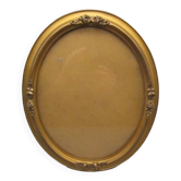Old oval frame in wood and gilded stucco