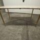 Marble coffee table with brass legs, height 46 cm.