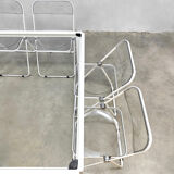 Plia' chairs by Giancarlo Piretti for Castelli with a table