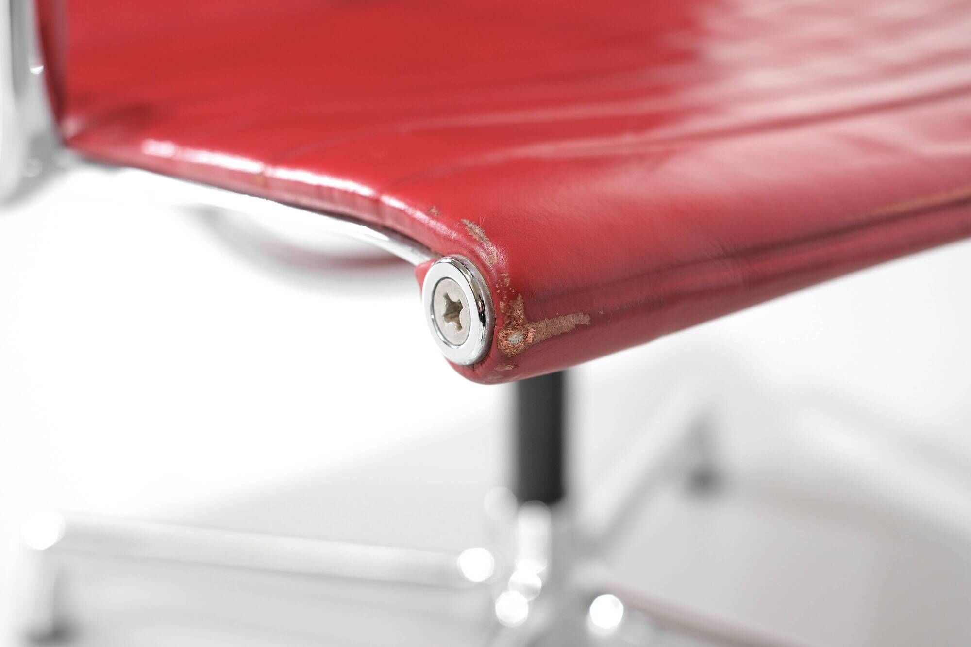 "EA 108" armchair in red leather, designed by Charles and Ray Eames for Vitra,