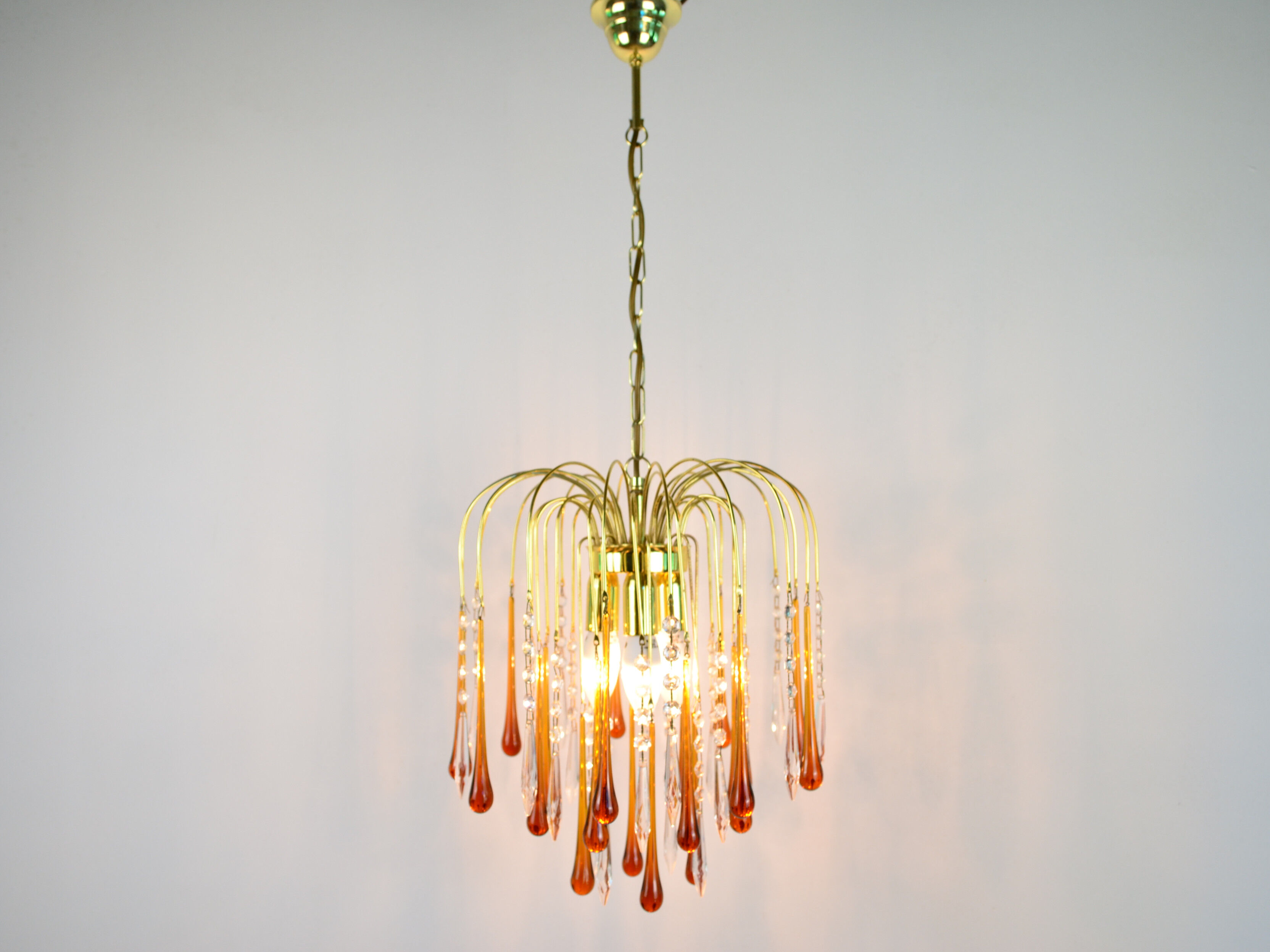 A pair of Mid Century 70's waterfall chandeliers. Murano glass amber drops. Paolo Venini style.