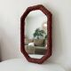 Vintage octagonal mirror in woven rattan.