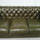 Three-seater green leather Chesterfield sofa