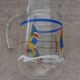 Vintage jug carafe for lemonade and juice, boats by the seaside, France.