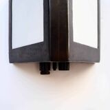 Double-sided patinated triangular wall light