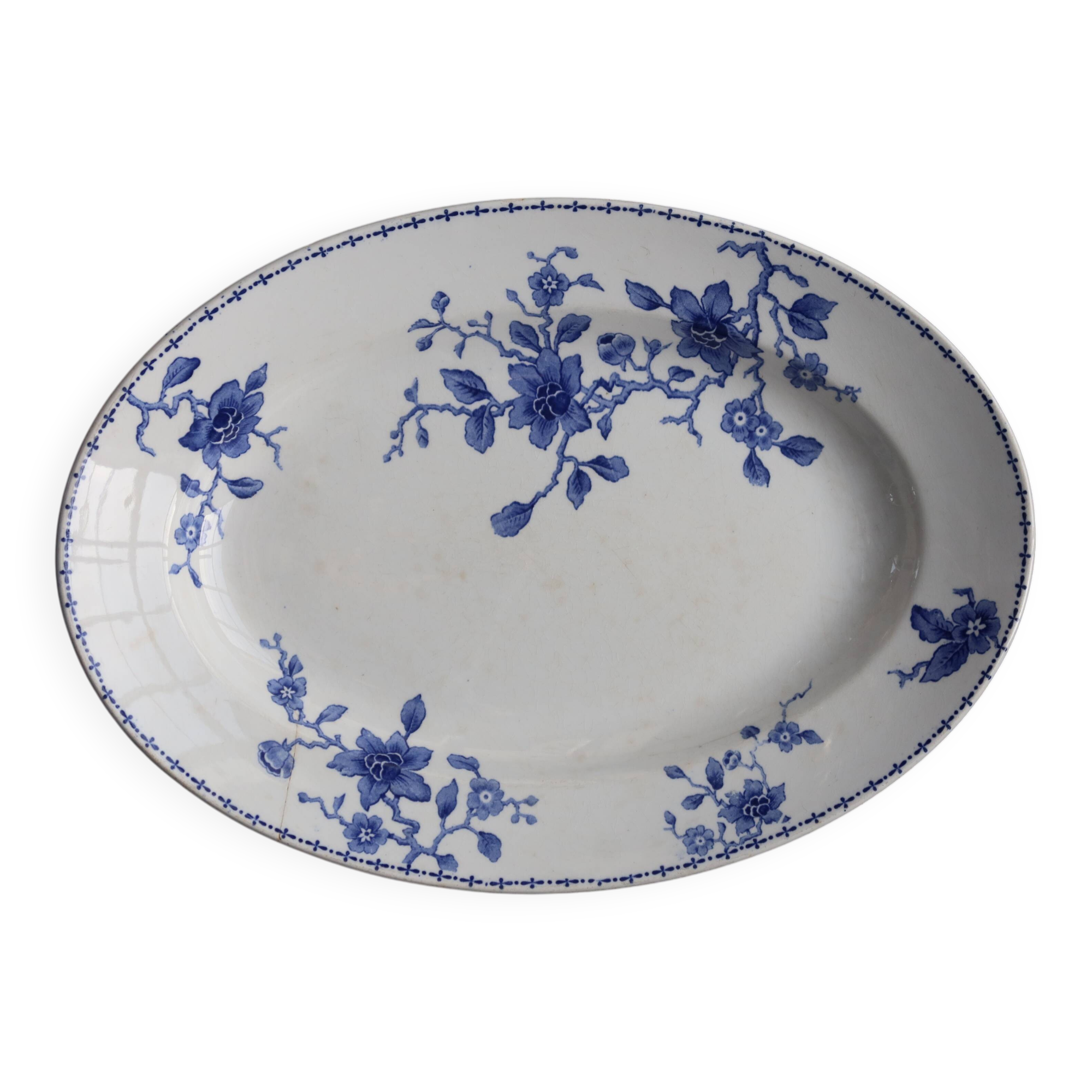 Antique serving dish in white and blue earthenware.