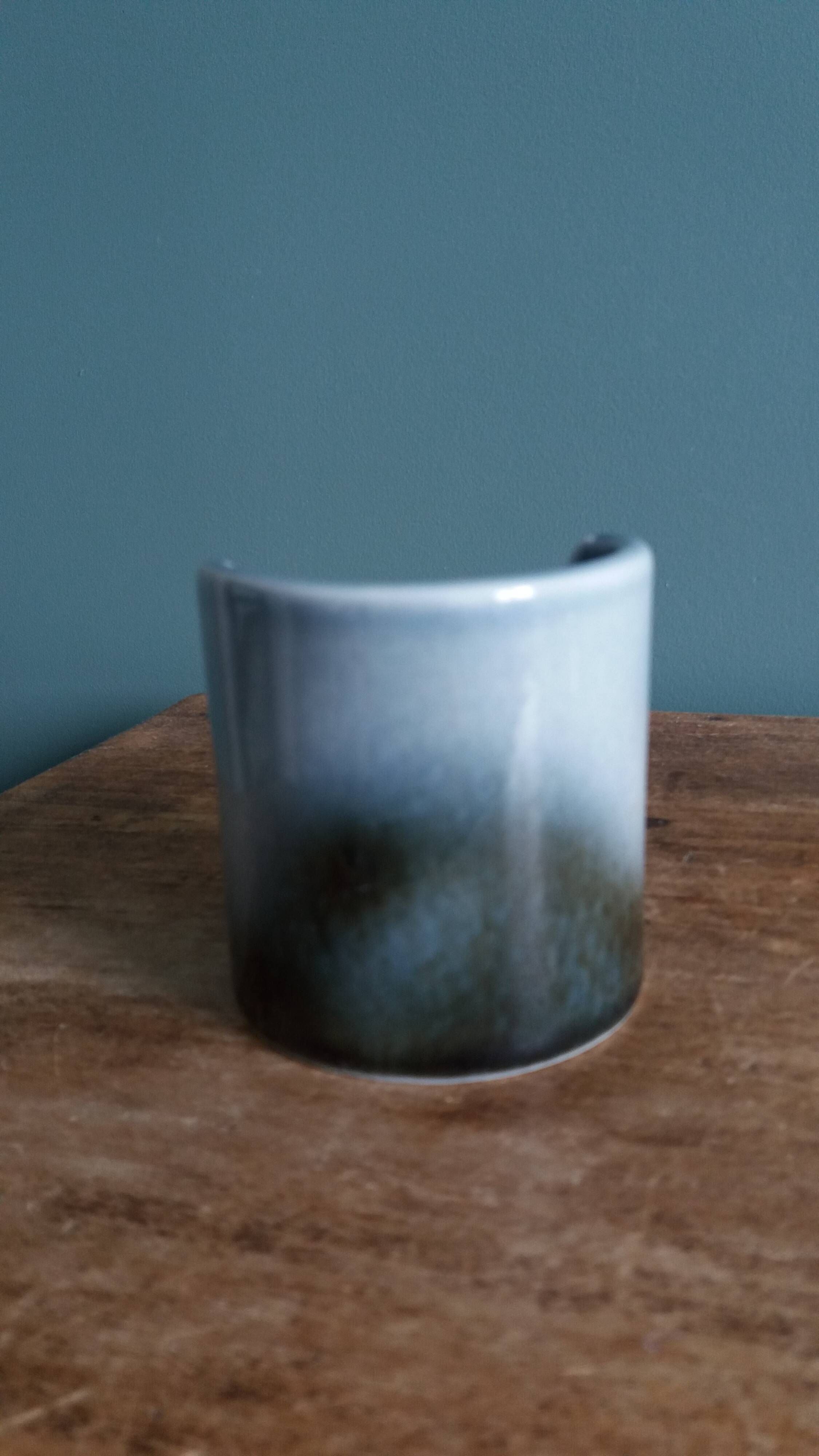 Vase Virebent porcelain cylindrical roll shape with a deep neck.