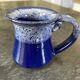 Small enamelled earthenware milk jug