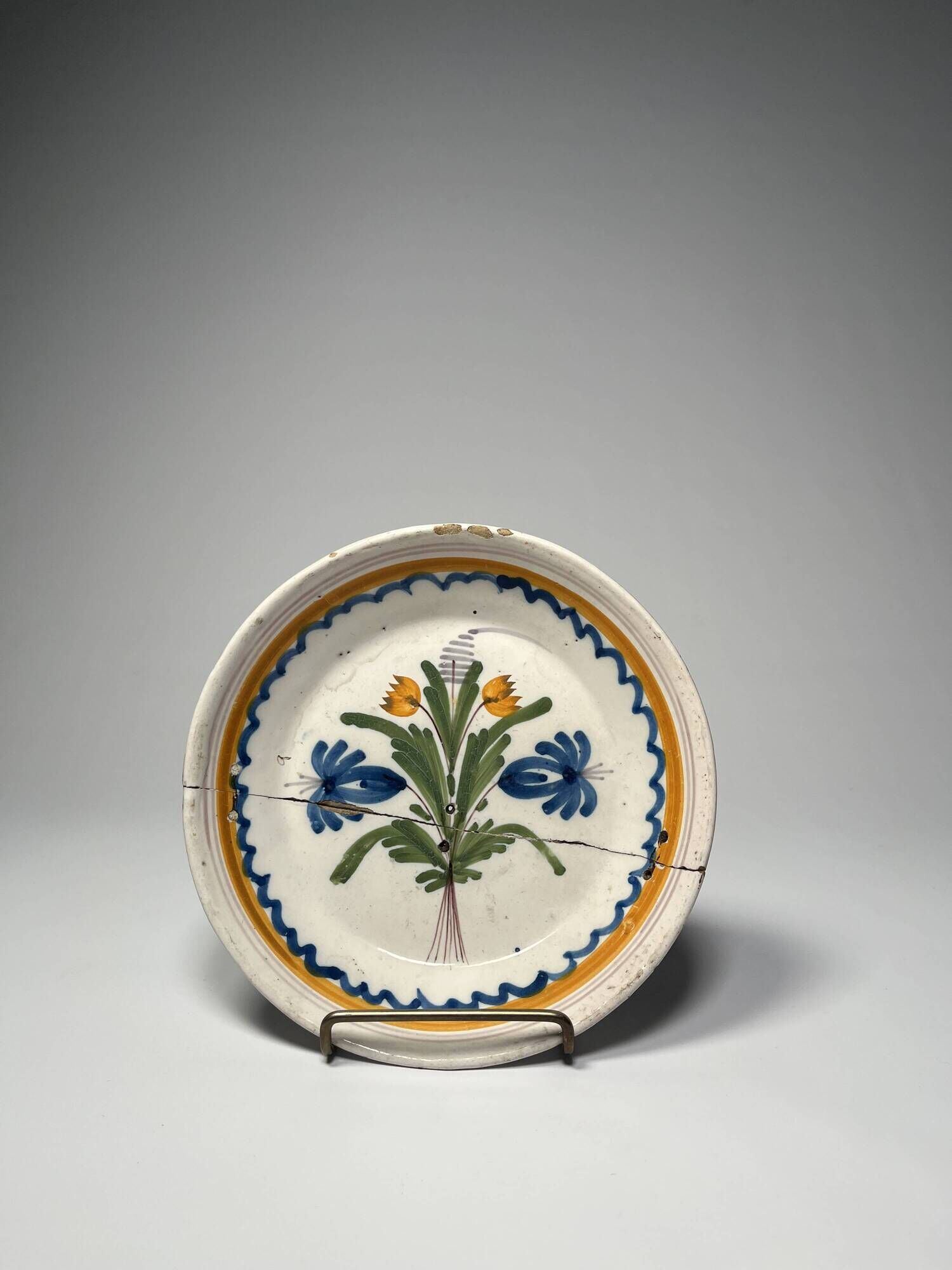 Two antique 18th-century faience plates, stapled.