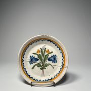 Two antique 18th-century faience plates, stapled.