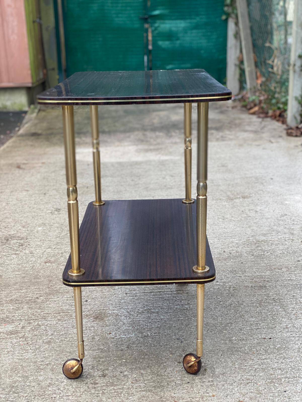 Brown rosewood rolling table with gold legs