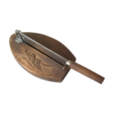 Old wooden bread cutter carved sheaf of wheat and metal deco kitchen Normandy countryside