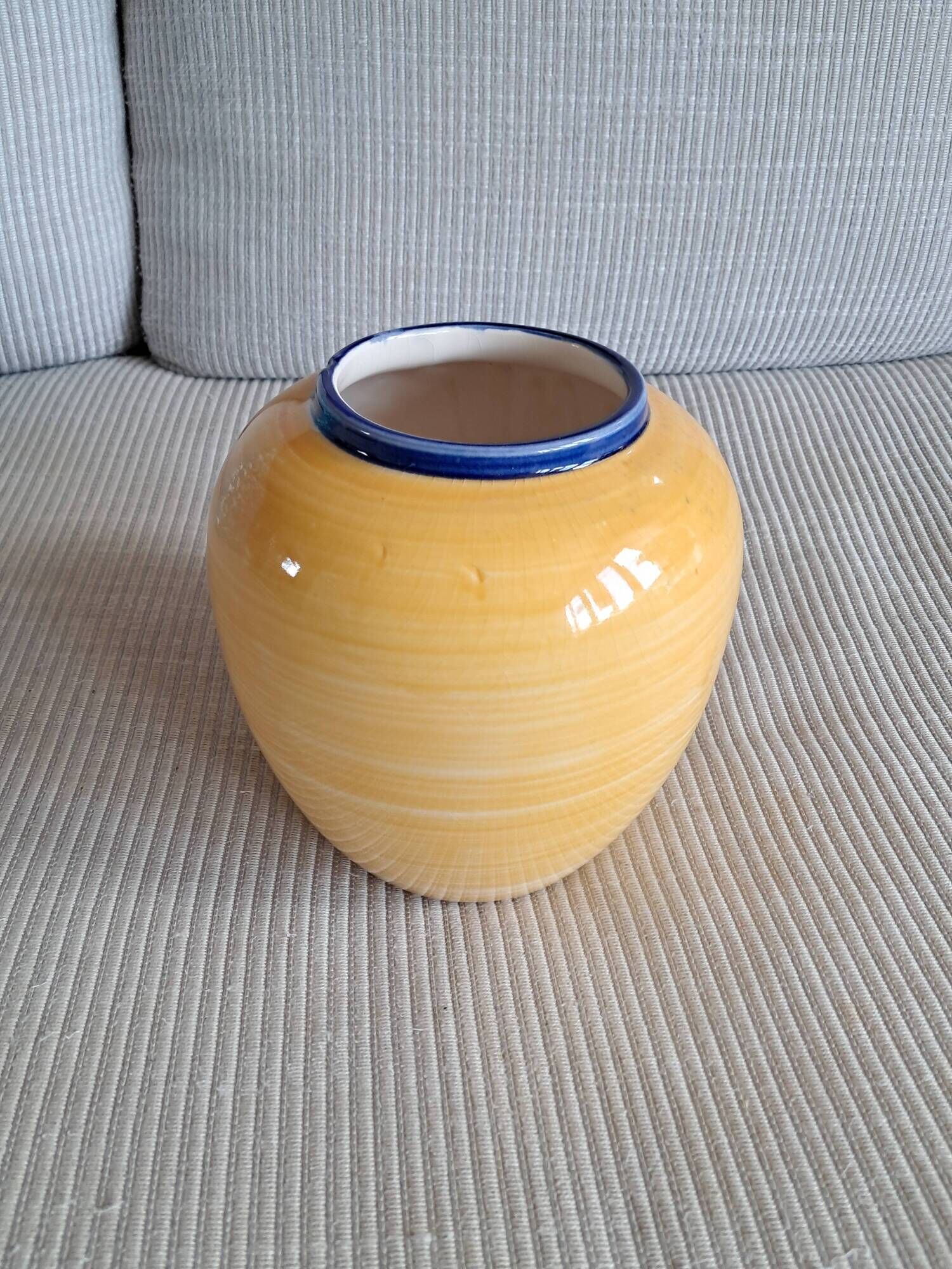 Vintage ceramic vase in a round shape.