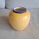 Vintage ceramic vase in a round shape.