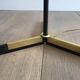 Designer floor lamp in black lacquered metal and brass