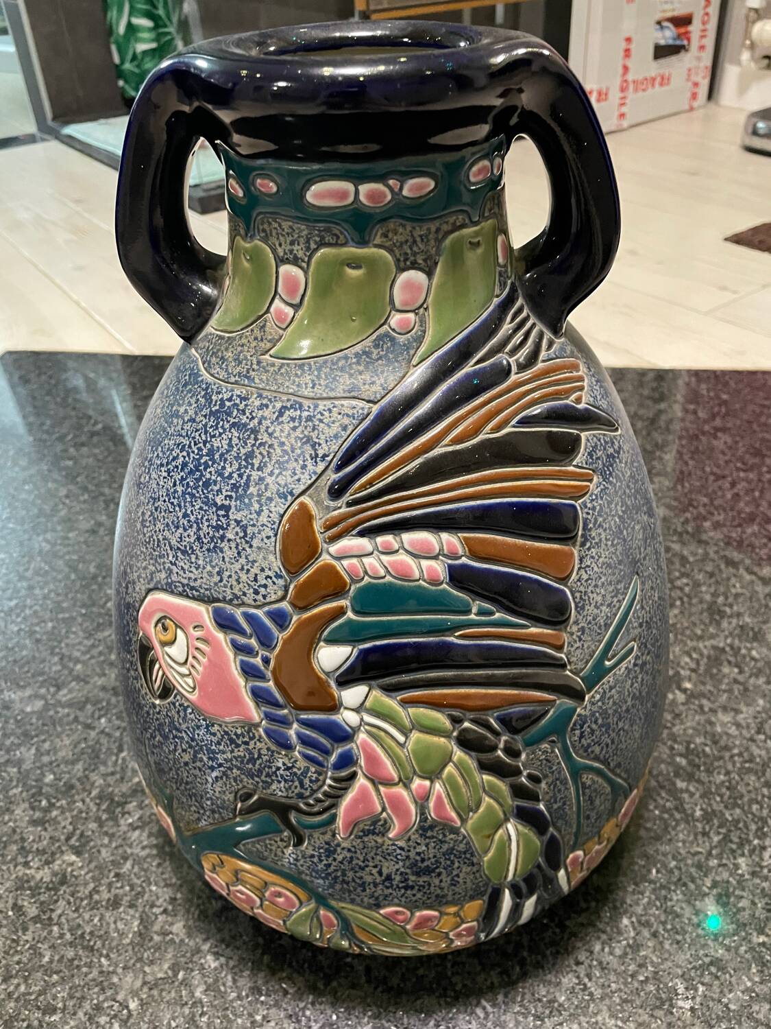 Large relief vase with parrot design