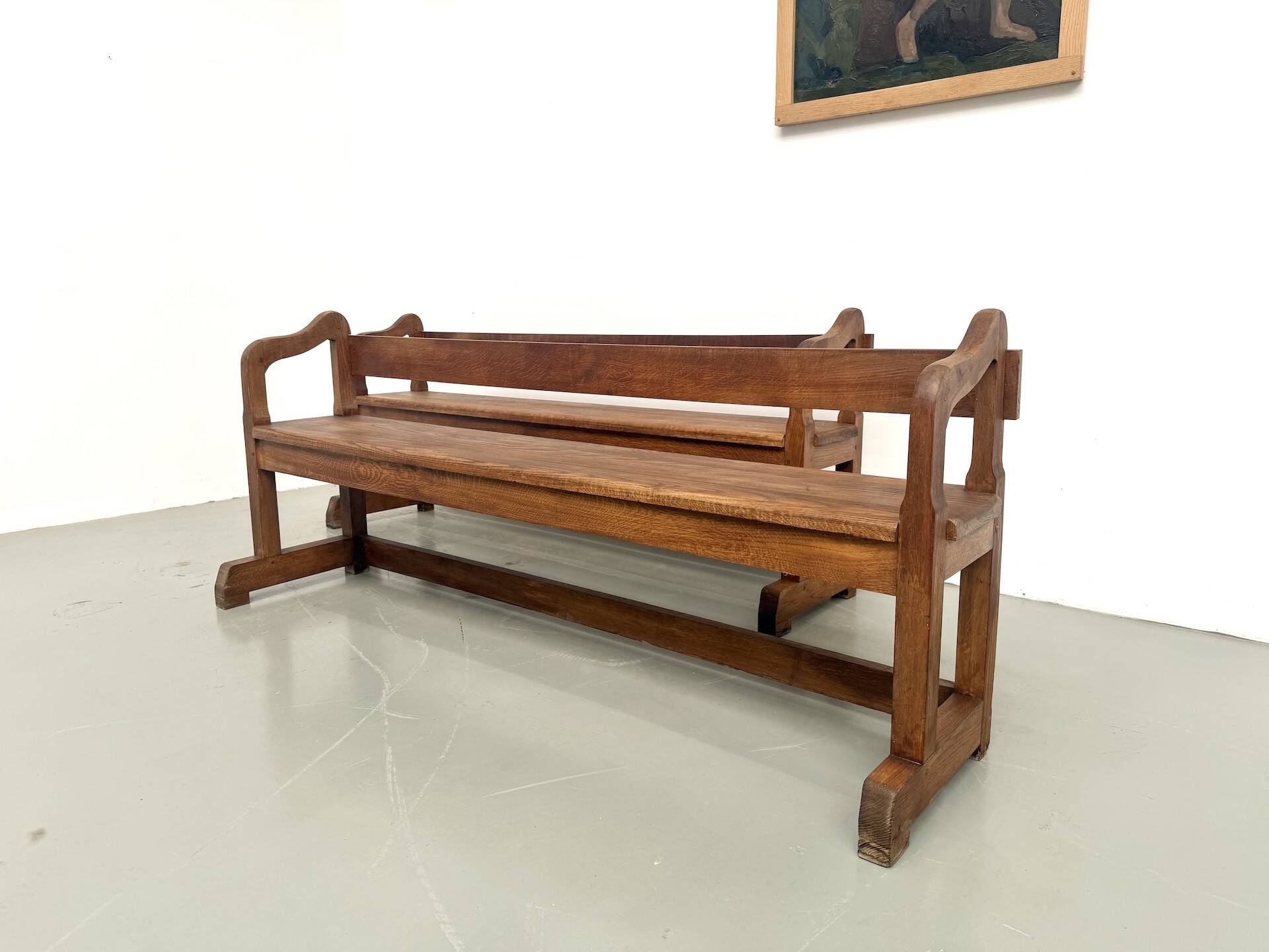 Pair of communal benches in solid oak, 1950s.